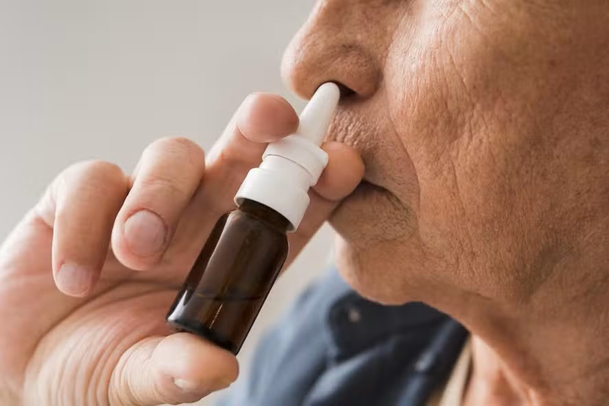 Close Up Old Man Using Nasal Spray
